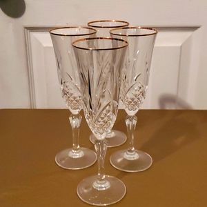 Set of crystal etched gold rim champagne flutes